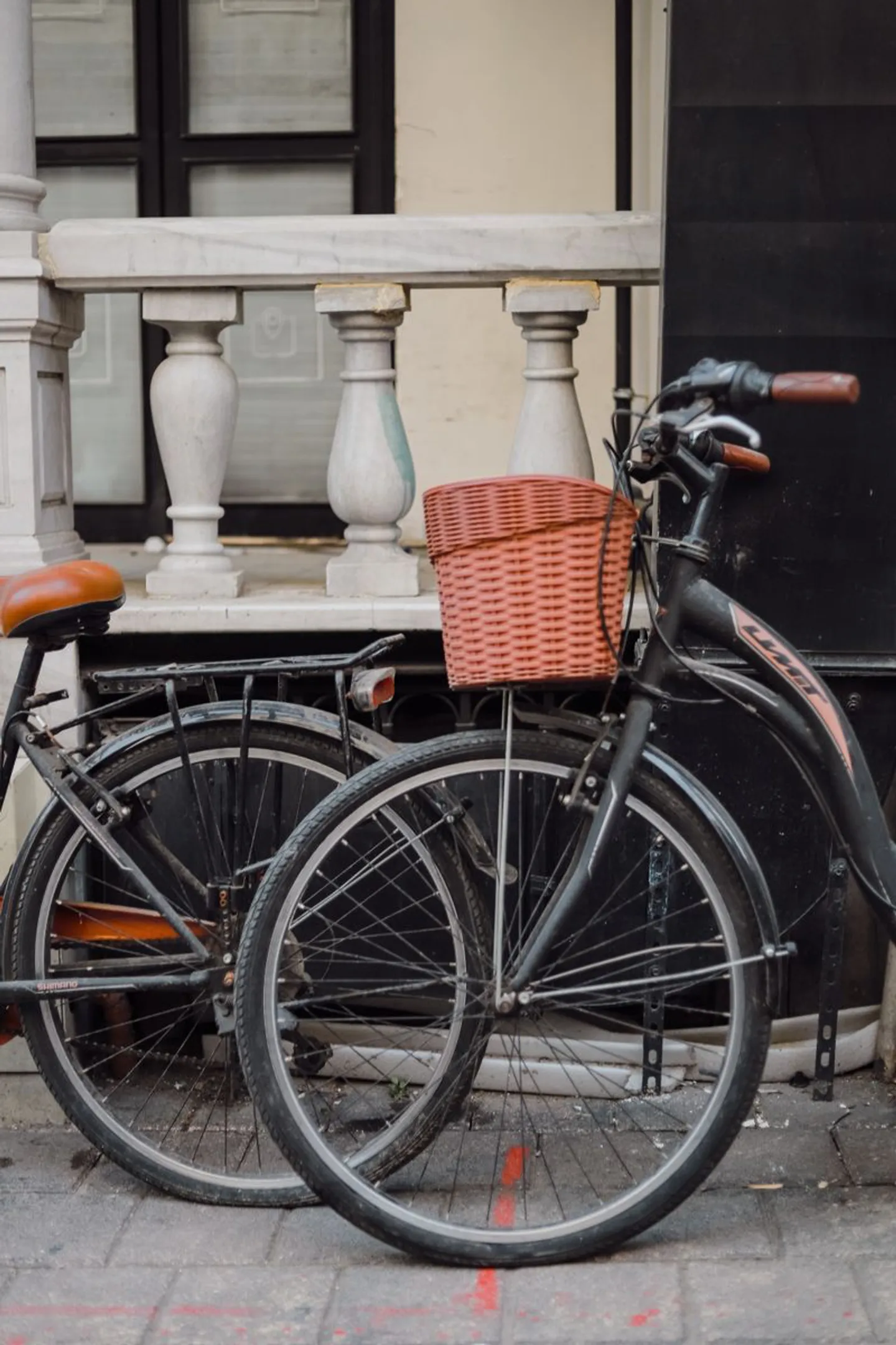Bicycle parked beside a vintage balcony in old Tirana